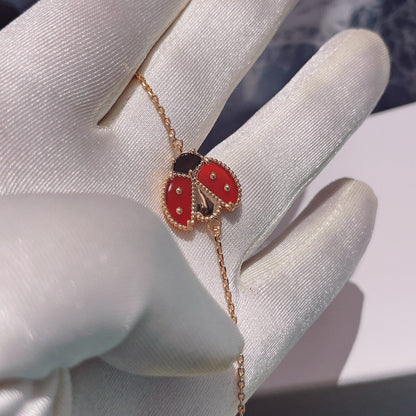 [NOVO] Armband mit Glücksfedermotiv 1, rosa-golden